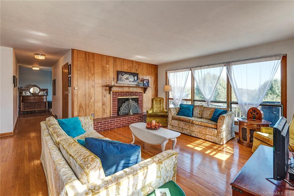 641 Newfound Road Leicester, NC 28748 - Photo 6 of 23 a living room with furniture fireplace and a large window