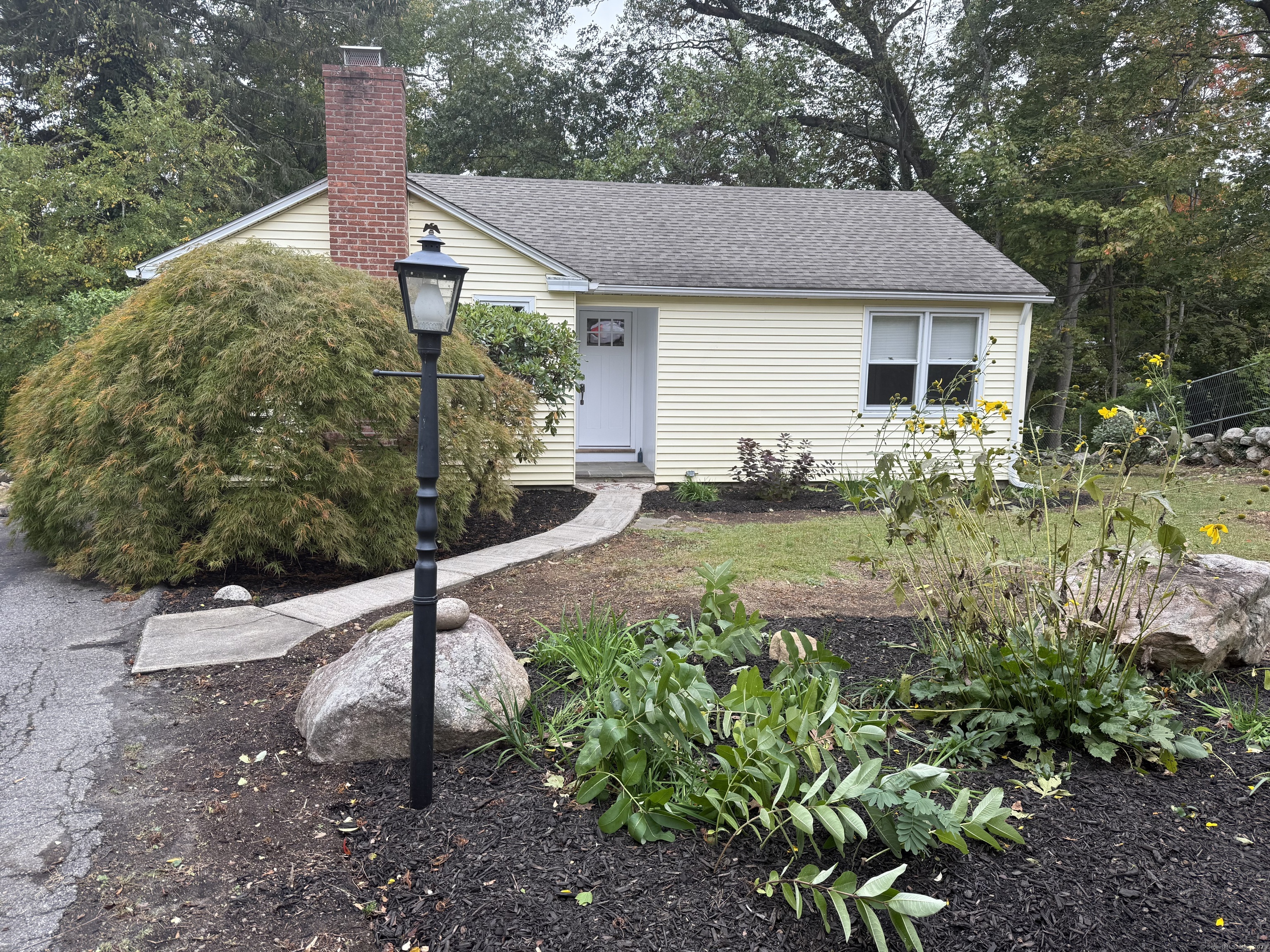 a front view of a house with garden