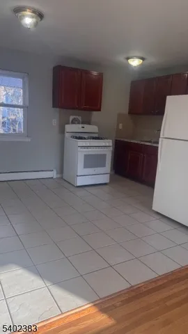 a kitchen with stainless steel appliances wooden cabinets and a stove top oven