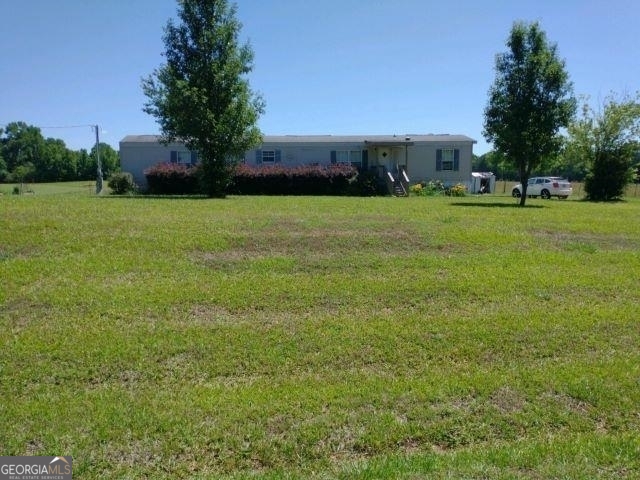 0 Tanyard Road Northeast Eatonton, GA 31024 - Photo 1 of 1 a view of building with trees in front of it
