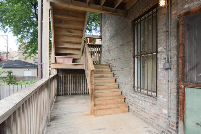 a view of entryway with wooden floor and a front door