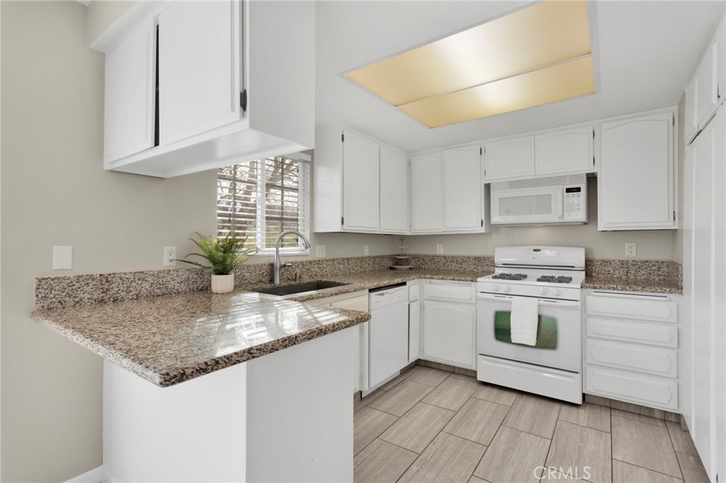 4875 Sunnyslope Road Phelan, CA 92371 - Photo 12 of 57 a kitchen with stainless steel appliances granite countertop a sink stove and cabinets