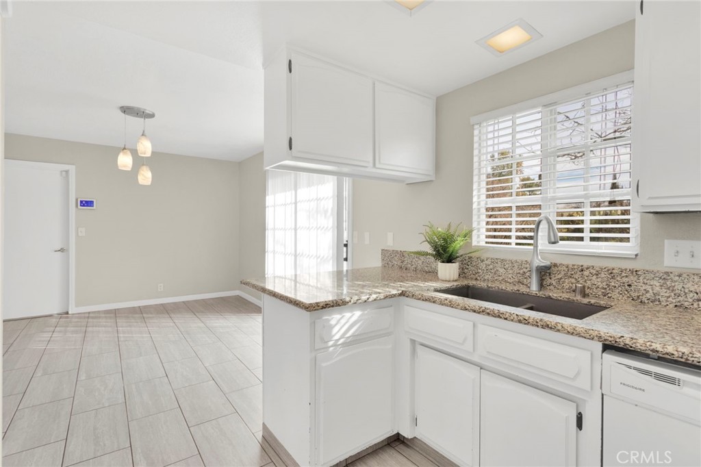 4875 Sunnyslope Road Phelan, CA 92371 - Photo 15 of 57 a kitchen with a sink cabinets and window