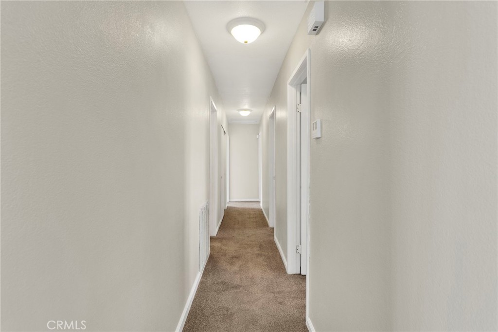 4875 Sunnyslope Road Phelan, CA 92371 - Photo 16 of 57 a view of a hallway with wooden floor