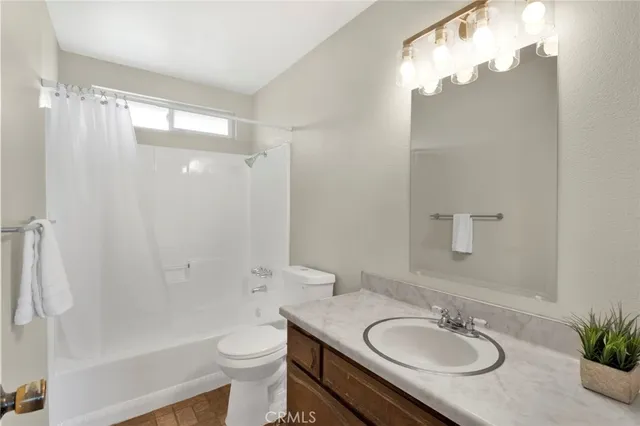 a bathroom with a sink a toilet and a large mirror