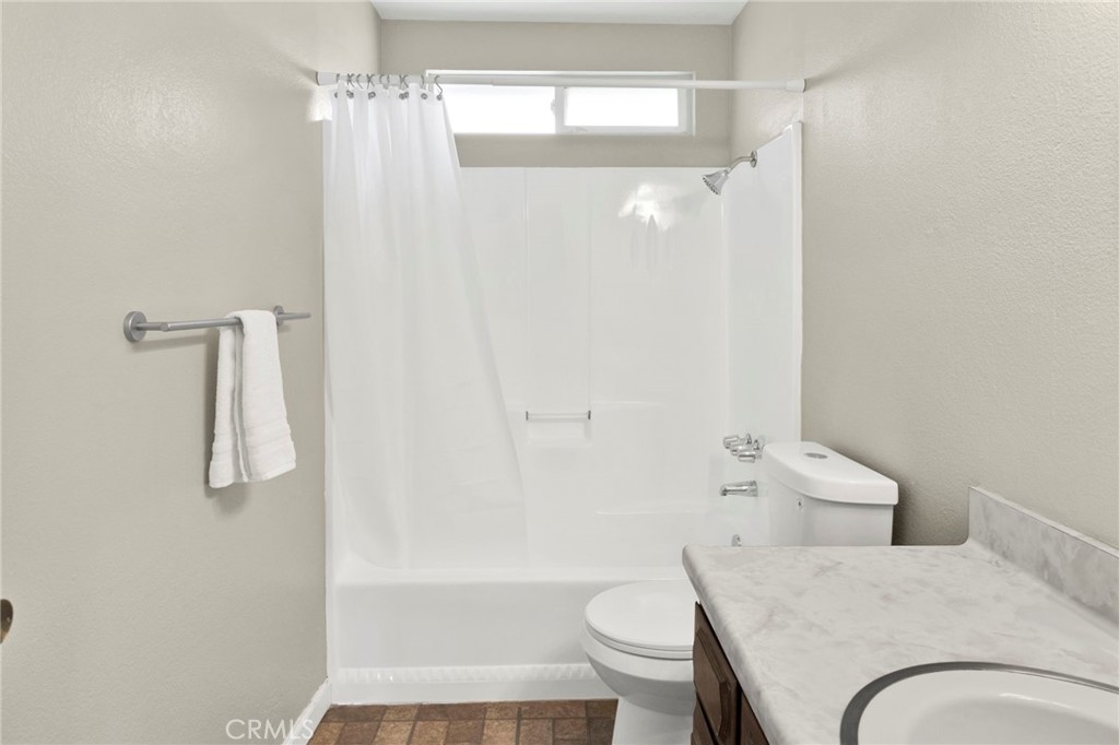 4875 Sunnyslope Road Phelan, CA 92371 - Photo 26 of 57 a bathroom with a granite countertop bathtub shower sink vanity and toilet