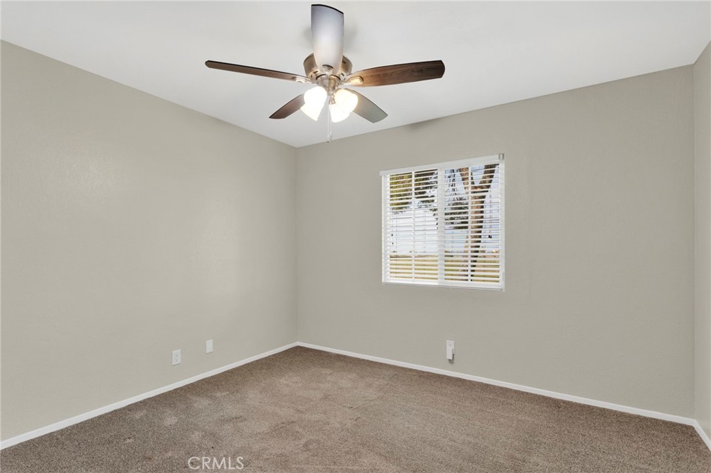 4875 Sunnyslope Road Phelan, CA 92371 - Photo 30 of 57 an empty room with a window and a fan