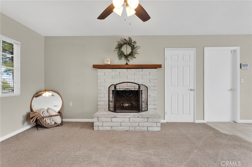 4875 Sunnyslope Road Phelan, CA 92371 - Photo 4 of 57 a living room with furniture and a fireplace