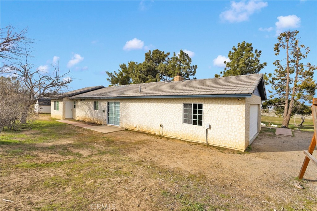 4875 Sunnyslope Road Phelan, CA 92371 - Photo 43 of 57 a front view of a house with a yard and garage