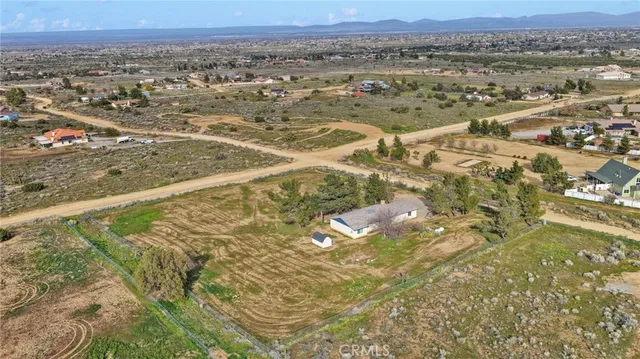 an aerial view of a residential houses with city view