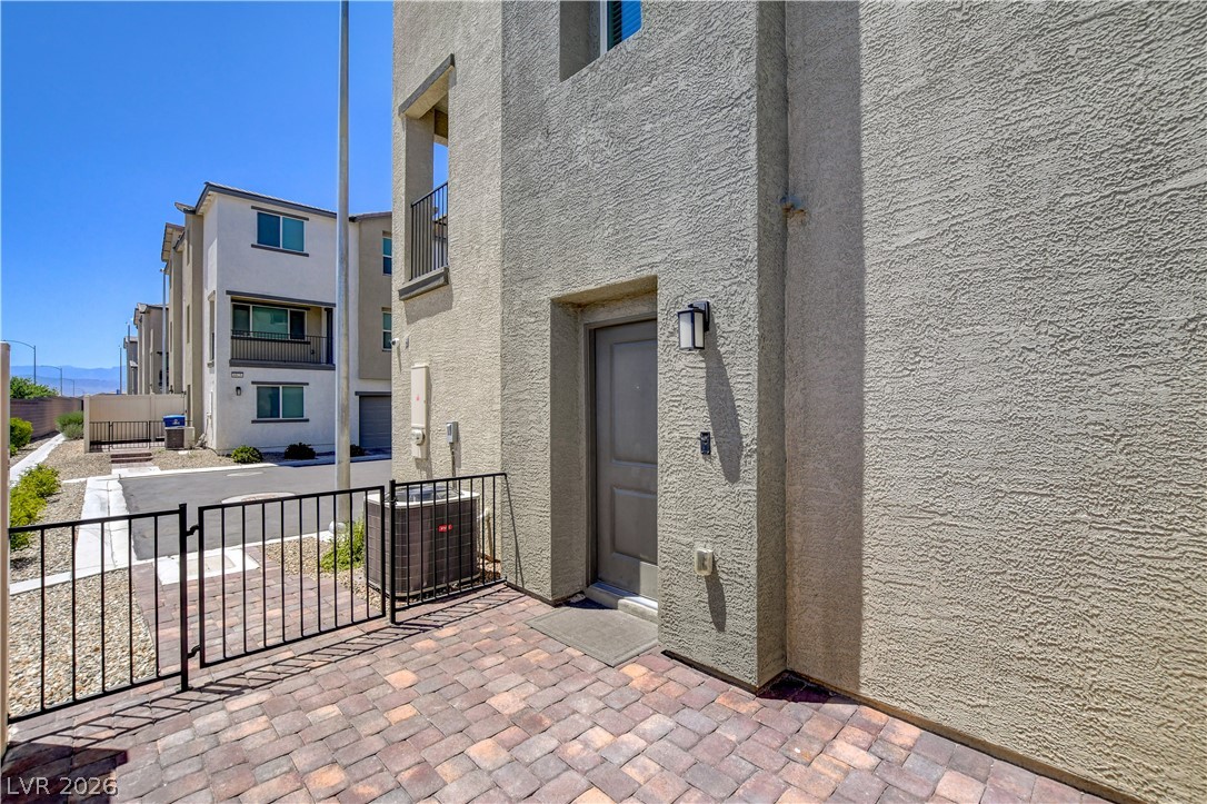 6924 Spicy Merlot Street North Las Vegas, NV 89086 - Photo 5 of 83 A private paver patio invites entry to this contemporary multi-level residence.
