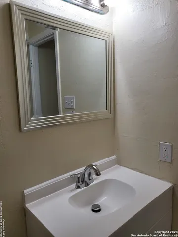 a bathroom with a sink and mirror