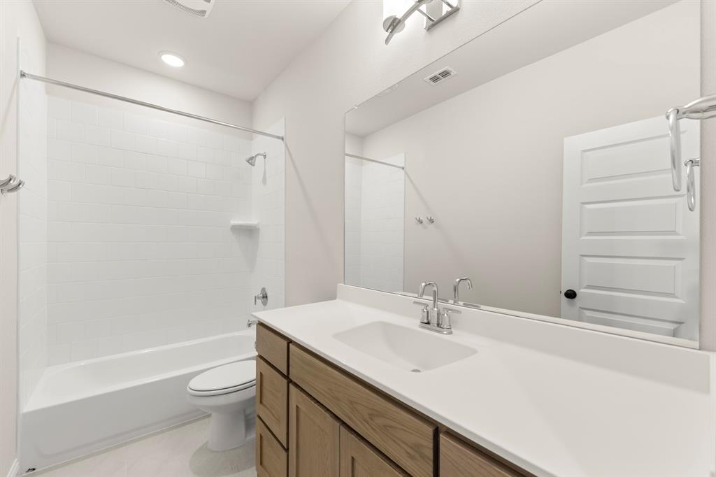 3900 Keya Drive Prosper, TX 75078 - Photo 25 of 36 a bathroom with a sink a toilet and shower