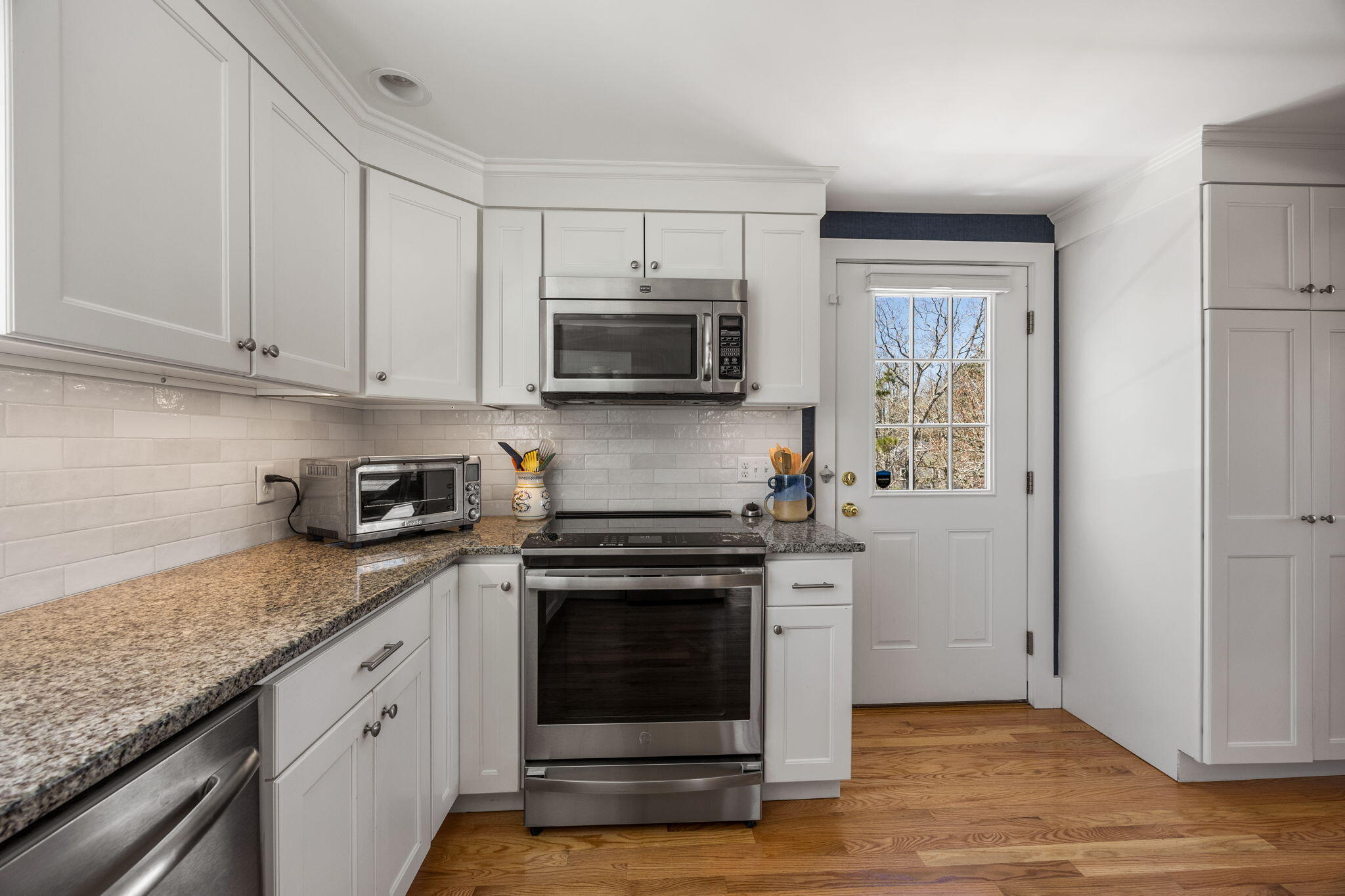 58 Stepping Stones Road Chatham, MA 02633 - Photo 8 of 52 a kitchen with granite countertop a stove a sink and a counter space