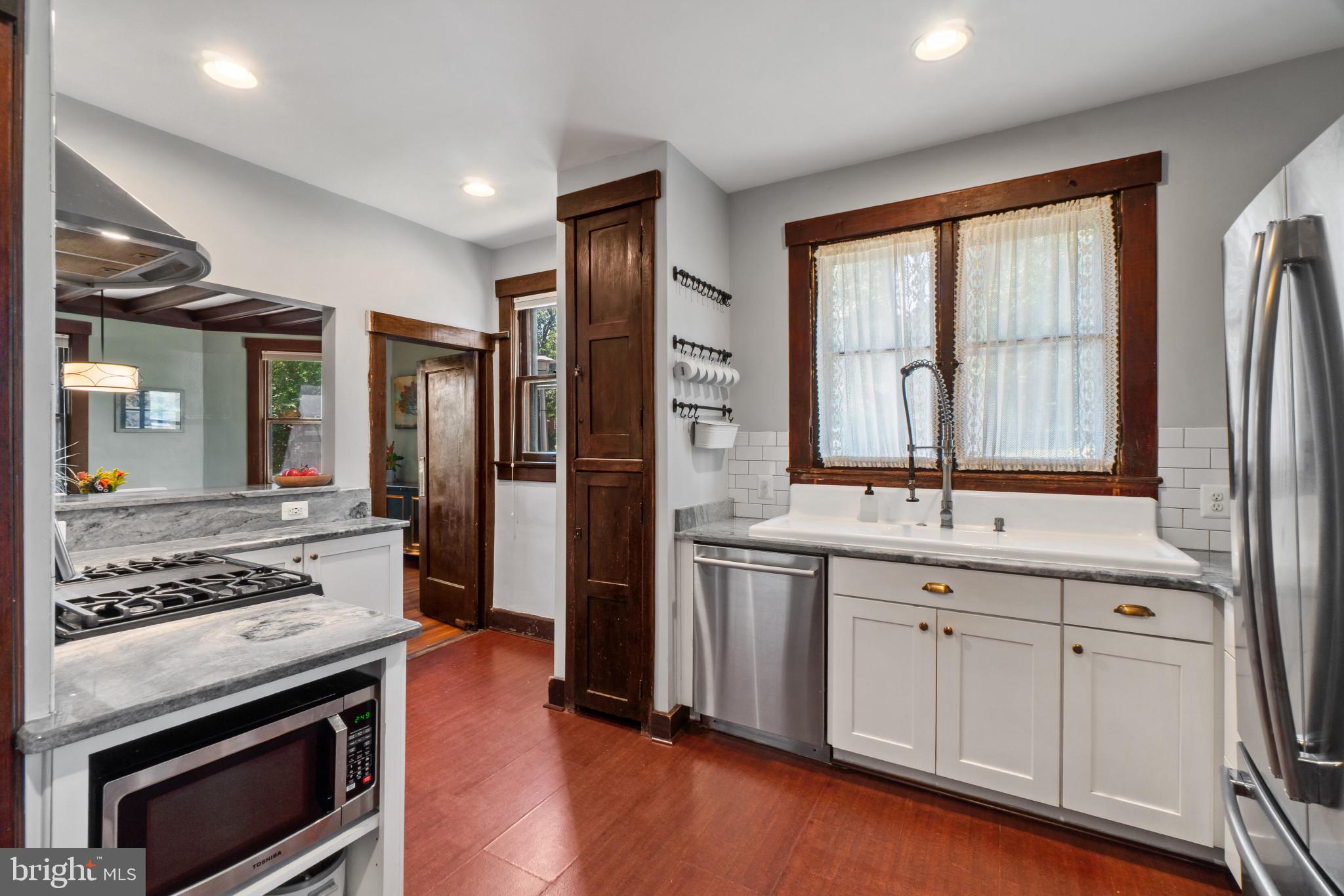 2900 Rueckert Avenue Baltimore, MD 21214 - Photo 13 of 40 a kitchen with stainless steel appliances a stove sink and refrigerator