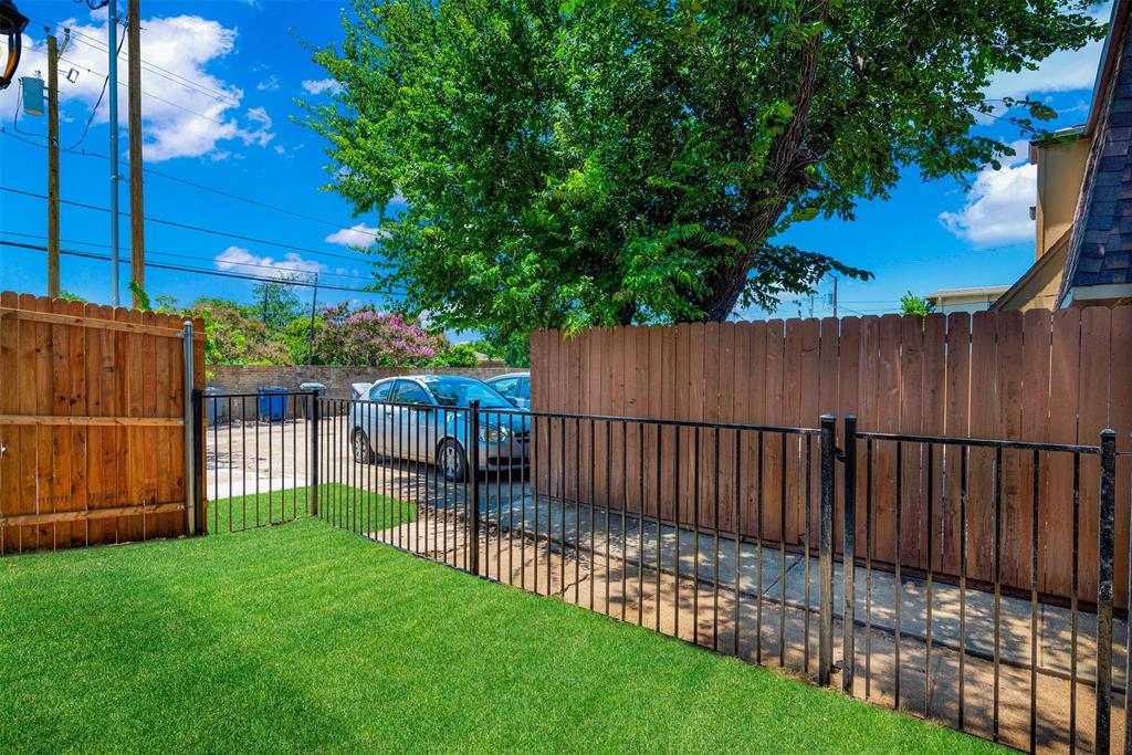 3676 Rickshaw Drive, Unit C Dallas, TX 75229 - Photo 20 of 22 A small, well-maintained grassy area, perfect for casual outdoor enjoyment and perhaps some light activities.