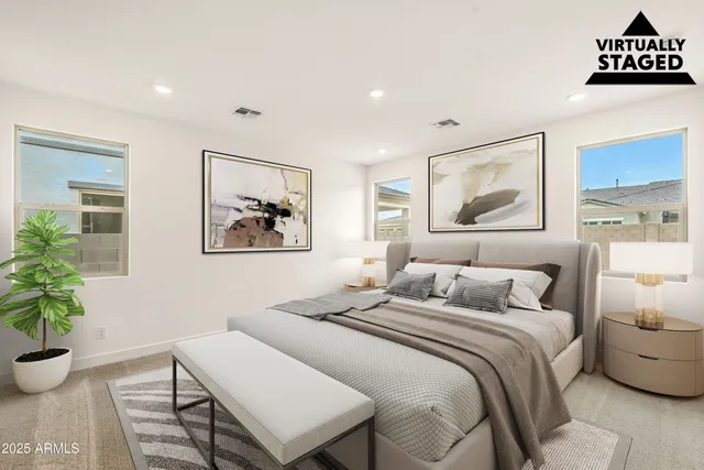 a bedroom with a bed and a potted plant