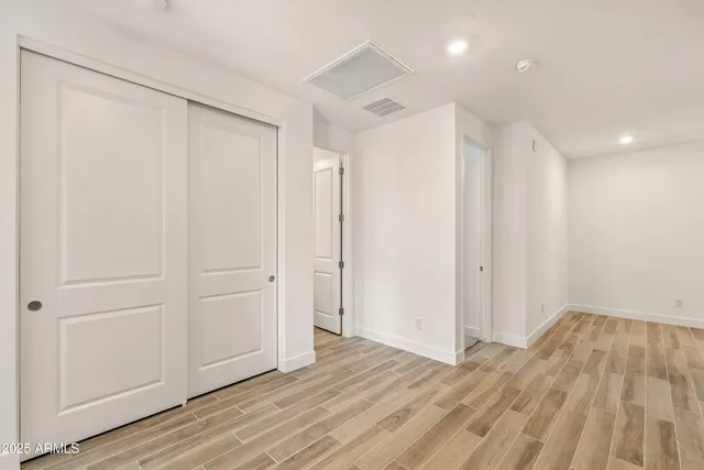 a view of a room with wooden floor