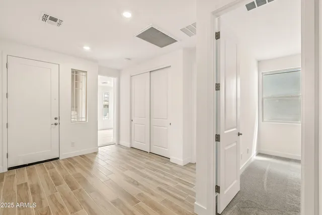 a view of a hallway with wooden floor