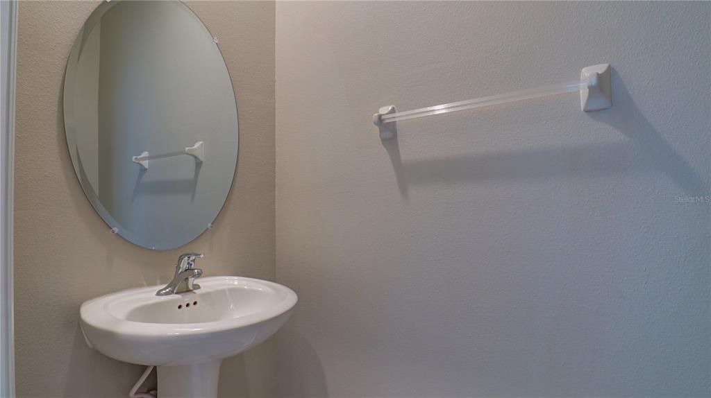 31632 Blue Passing Loop Wesley Chapel, FL 33545 - Photo 20 of 48 a bathroom with a sink a mirror and a