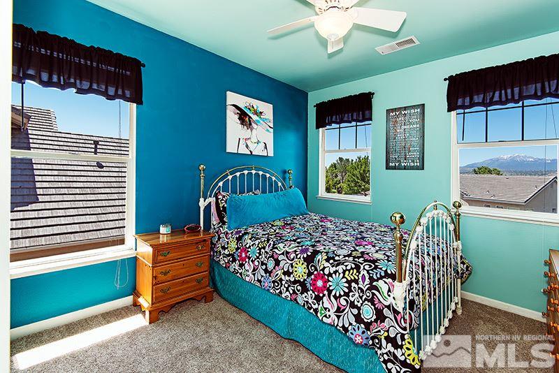 9628 Rolling Rock Way Reno, NV 89521 - Photo 18 of 23 a bed room with a bed and a chair