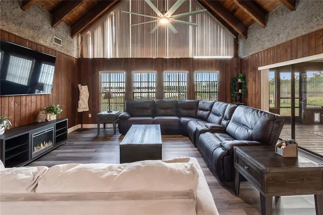 a living room with furniture fireplace and flat screen tv