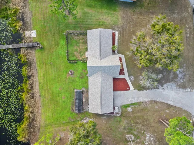 an aerial view of a house with a yard