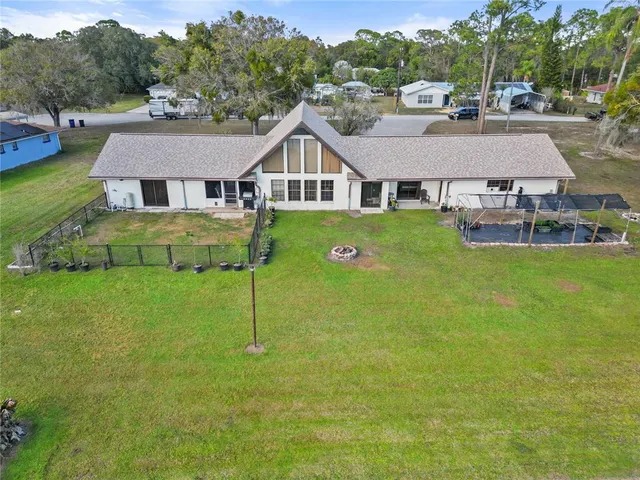 a aerial view of a house with a yard table and chairs