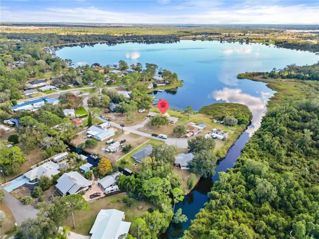 an aerial view of ocean and residential houses with outdoor space