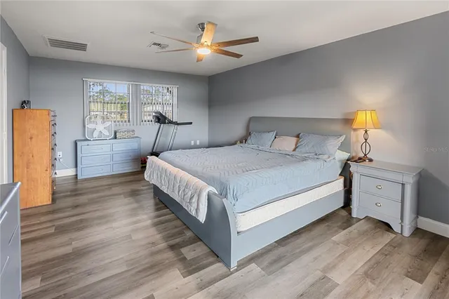 a bedroom with a bed and a dresser with window