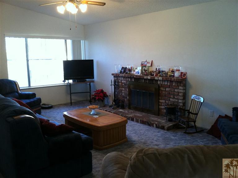 45472 Yale Street Indio, CA 92201 - Photo 9 of 23 a living room with furniture a flat screen tv and a window