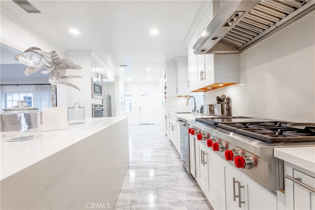 7847 Brookmill Road Downey, CA 90241 - Photo 13 of 71 a kitchen with stainless steel appliances granite countertop a stove and a sink