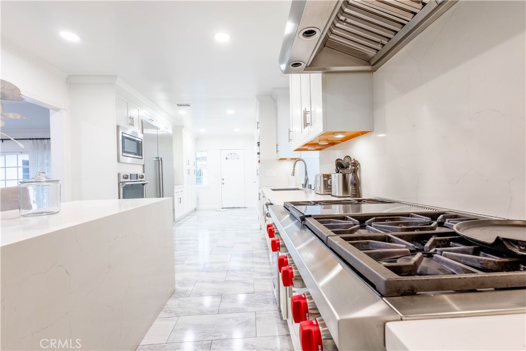 7847 Brookmill Road Downey, CA 90241 - Photo 14 of 71 a kitchen with stainless steel appliances granite countertop a stove and a sink