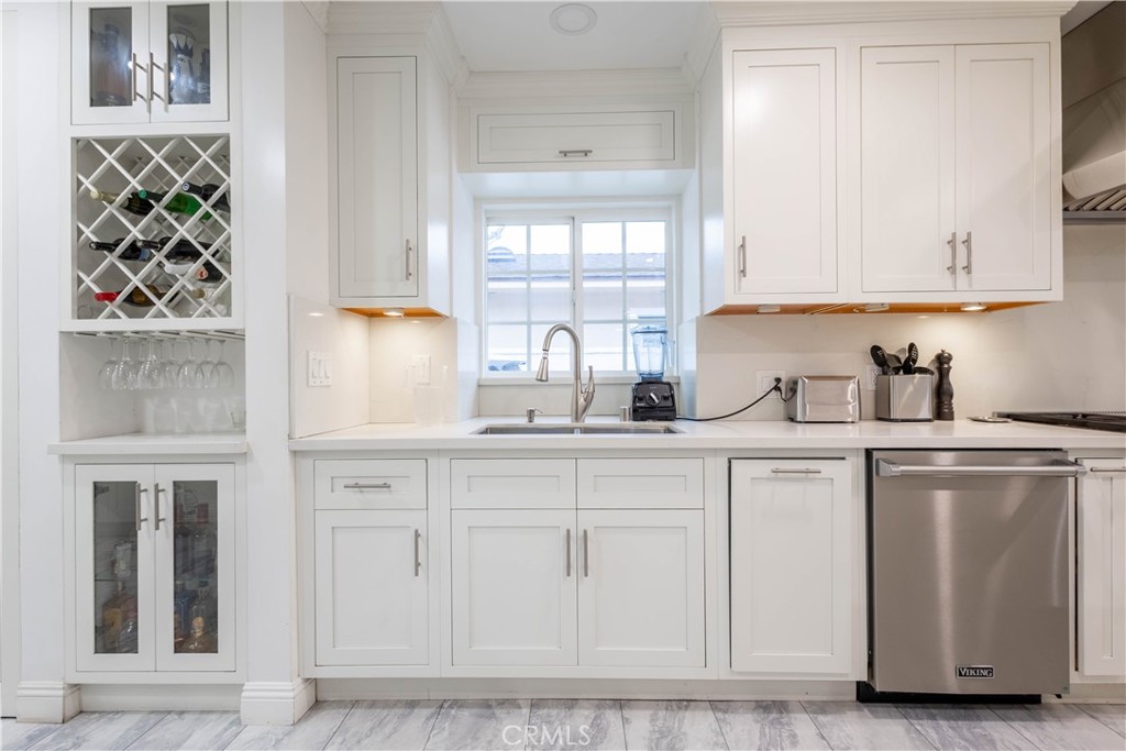 7847 Brookmill Road Downey, CA 90241 - Photo 18 of 71 a kitchen with white cabinets and sink