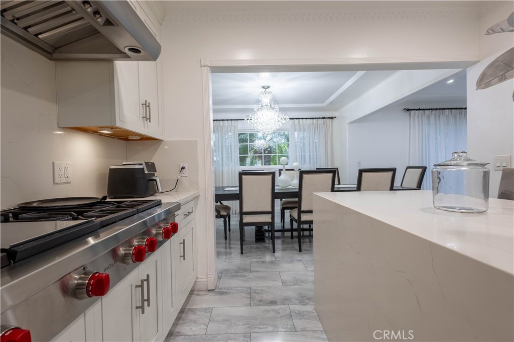 7847 Brookmill Road Downey, CA 90241 - Photo 21 of 71 a kitchen with stove a sink and a stove top oven