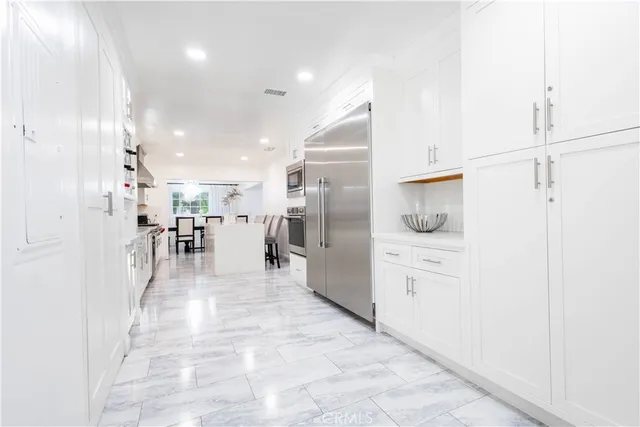 a spacious bedroom with a bed and a couch