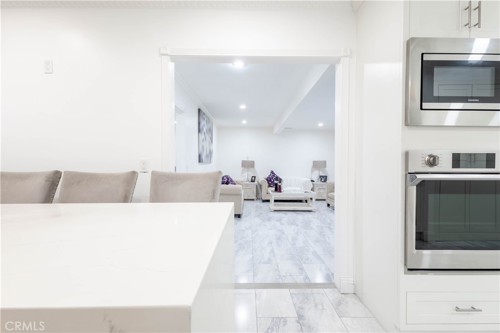 7847 Brookmill Road Downey, CA 90241 - Photo 24 of 71 a living room with stainless steel appliances kitchen island granite countertop a sink and a microwave