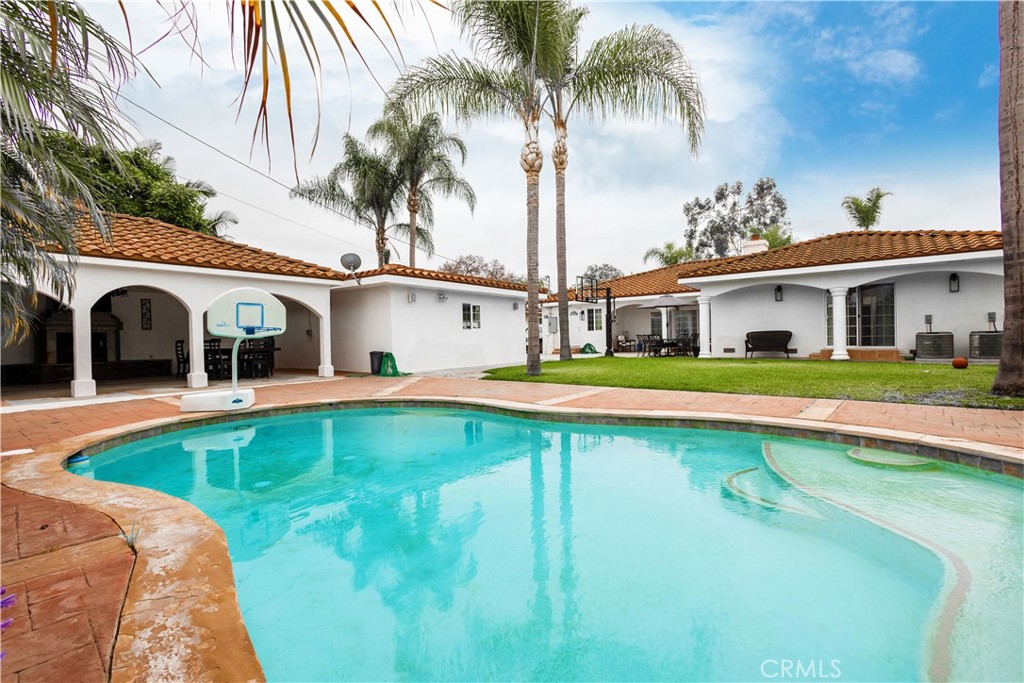 7847 Brookmill Road Downey, CA 90241 - Photo 3 of 71 a swimming pool with outdoor seating and yard