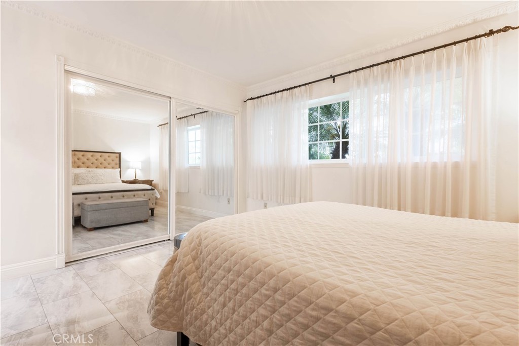 7847 Brookmill Road Downey, CA 90241 - Photo 36 of 71 a bedroom with a bed and a large window