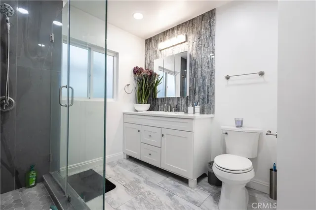 a large bed sitting in a bedroom next to a window and a fireplace