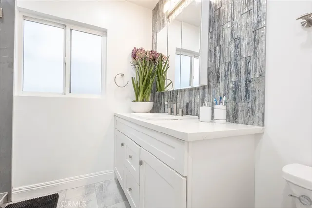 a bedroom with a bed and a night stand