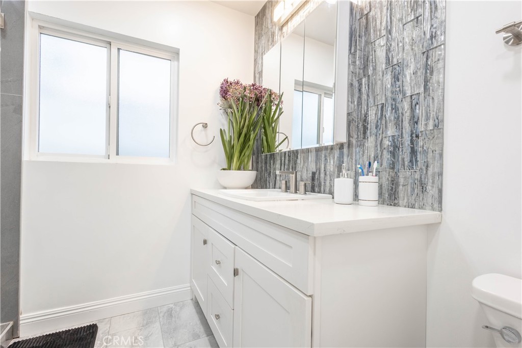 7847 Brookmill Road Downey, CA 90241 - Photo 40 of 71 a bathroom with a sink and a mirror