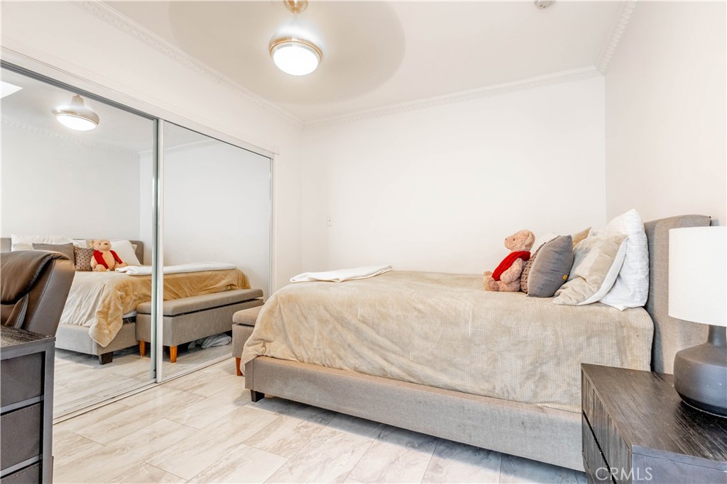 7847 Brookmill Road Downey, CA 90241 - Photo 43 of 71 a bedroom with a bed and wooden floor