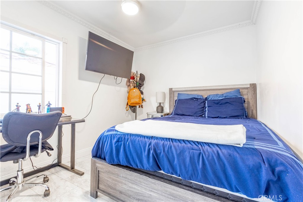 7847 Brookmill Road Downey, CA 90241 - Photo 44 of 71 a bedroom with a bed and wooden floor