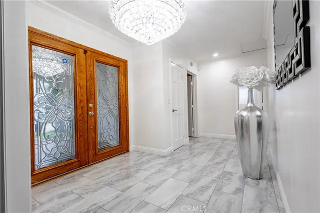 a large kitchen with stainless steel appliances a sink a stove and cabinets