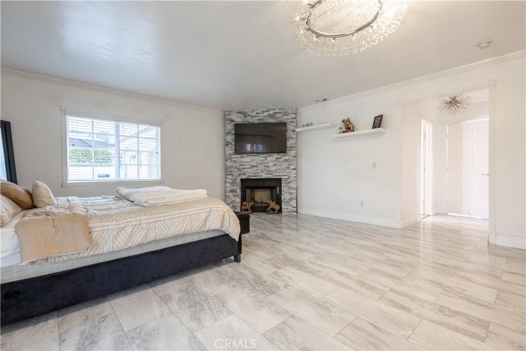7847 Brookmill Road Downey, CA 90241 - Photo 54 of 71 a large bed sitting in a bedroom next to a window and a fireplace