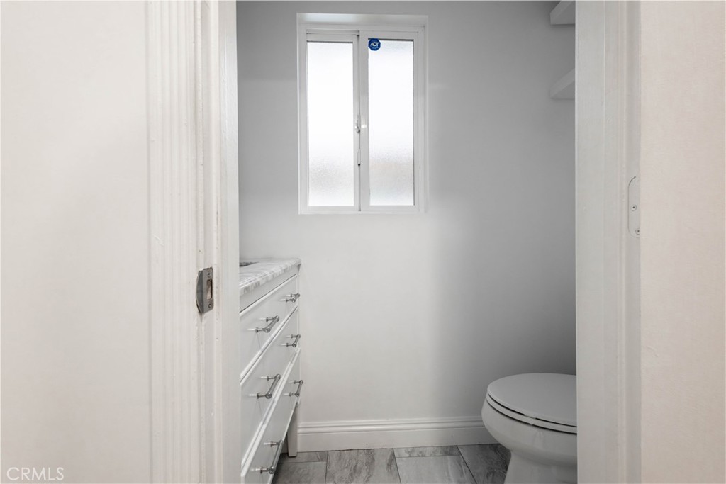 7847 Brookmill Road Downey, CA 90241 - Photo 57 of 71 a white toilet sitting next to a window