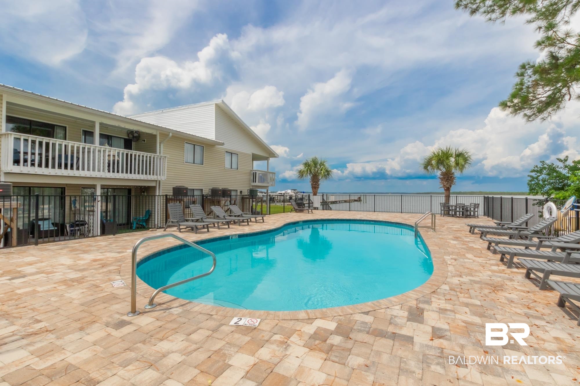 25925 -C Canal Road, Unit 203 Orange Beach, AL 36561 - Photo 36 of 57 View of swimming pool with a water view and a patio