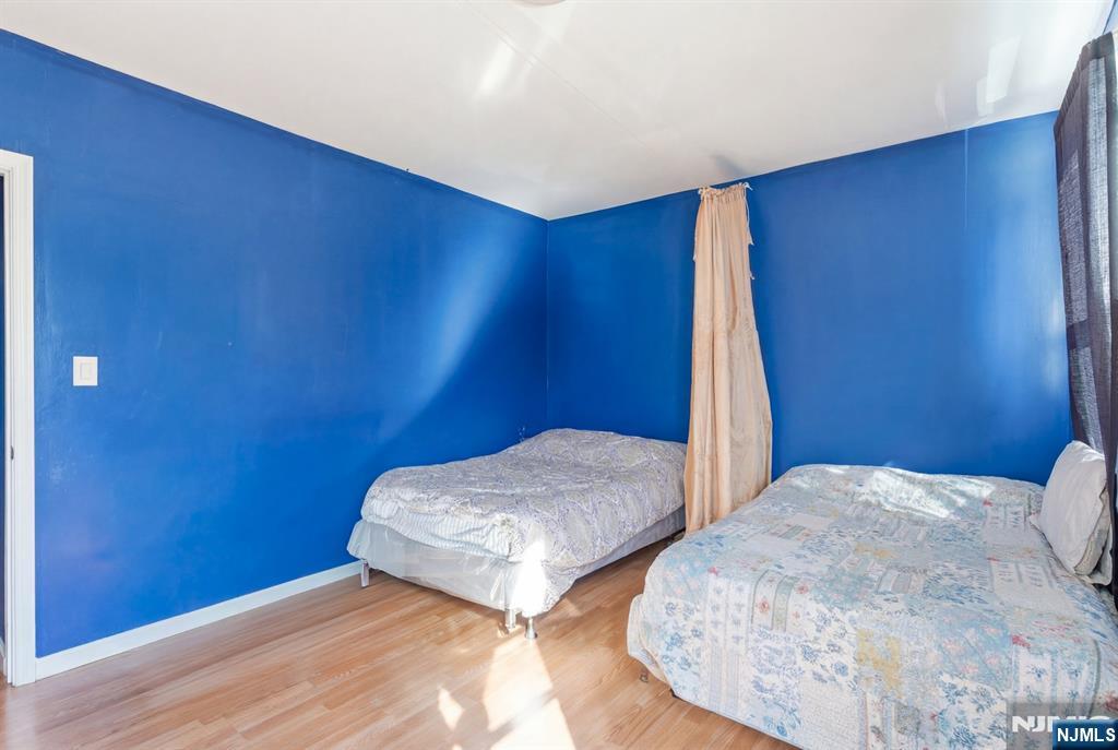 29 6th Avenue Newark, NJ 07104 - Photo 17 of 21 a bedroom with two beds and painted walls
