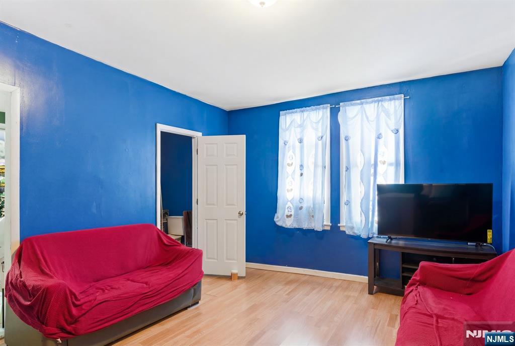 29 6th Avenue Newark, NJ 07104 - Photo 4 of 21 a bedroom with a bed and a flat screen tv